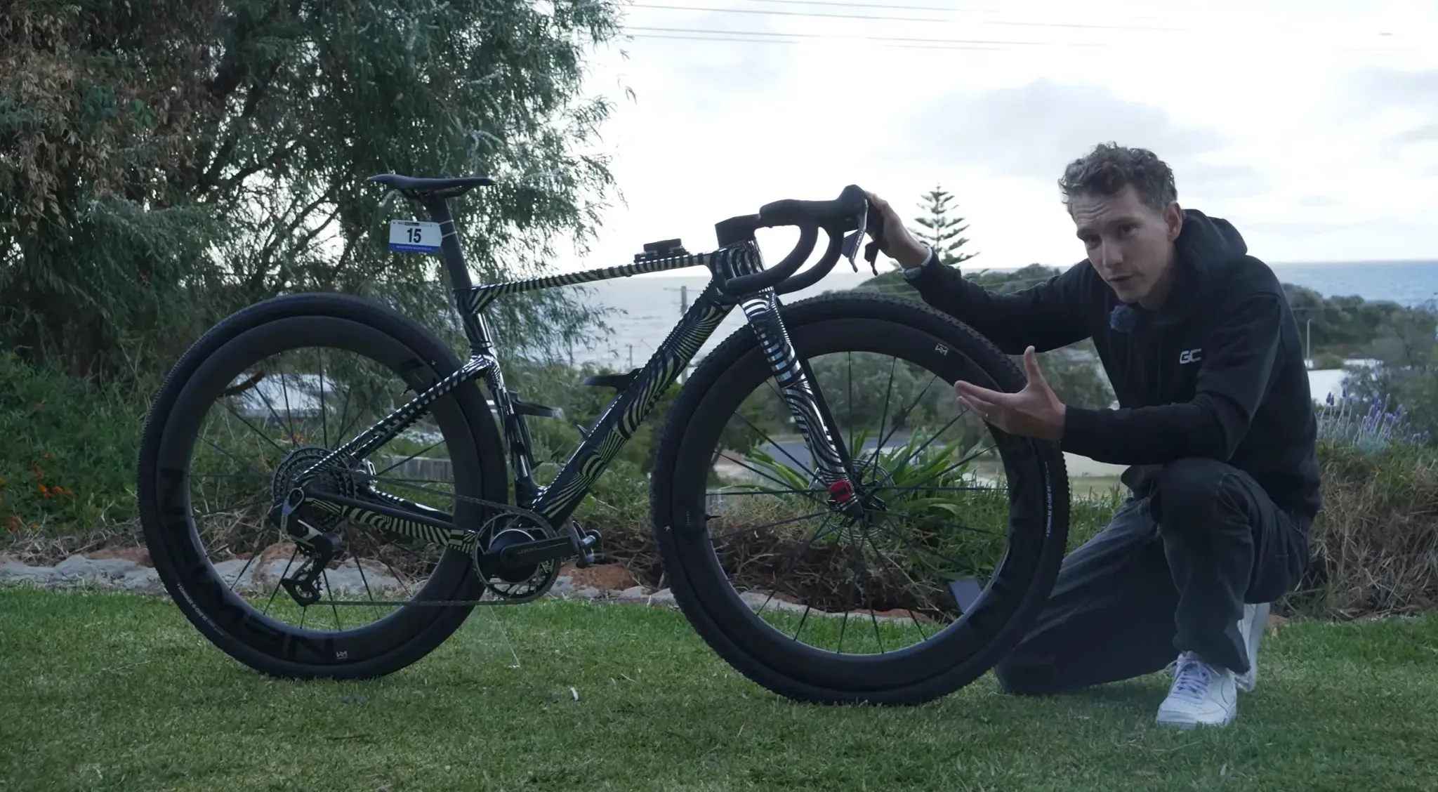 A GCN Tech video still showing a presenter beside the patterned ROSE 32-inch gravel prototype